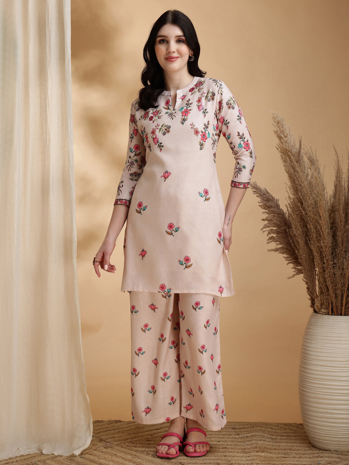 A beige linen co-ord set featuring a floral print tunic with a Chinese collar and matching palazzo pants.