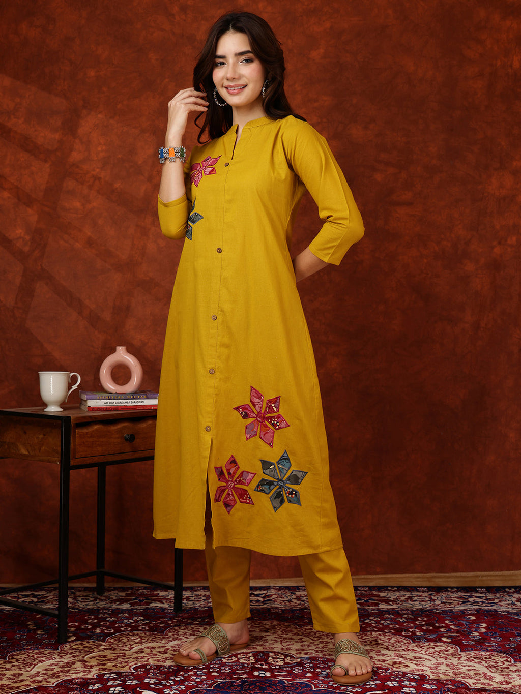 Mustard yellow front-buttoned kurta with placement floral print and matching trousers.
