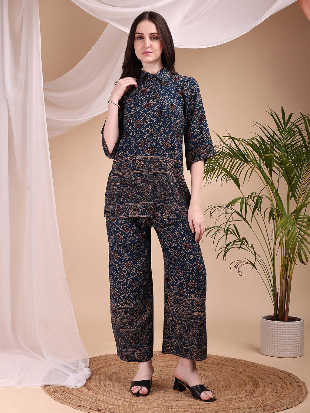 Model wearing a Navy Blue co-ord set with intricate floral and paisley motifs, featuring a collared shirt and palazzo pants.