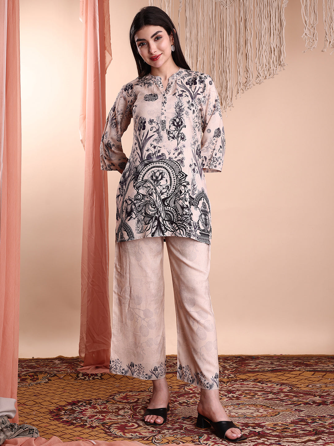 Woman wearing a beige floral and paisley printed rayon tunic and matching palazzo pants co-ord set.