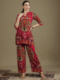 A woman wearing a pink ethnic printed tunic and matching palazzo pants co-ord set.