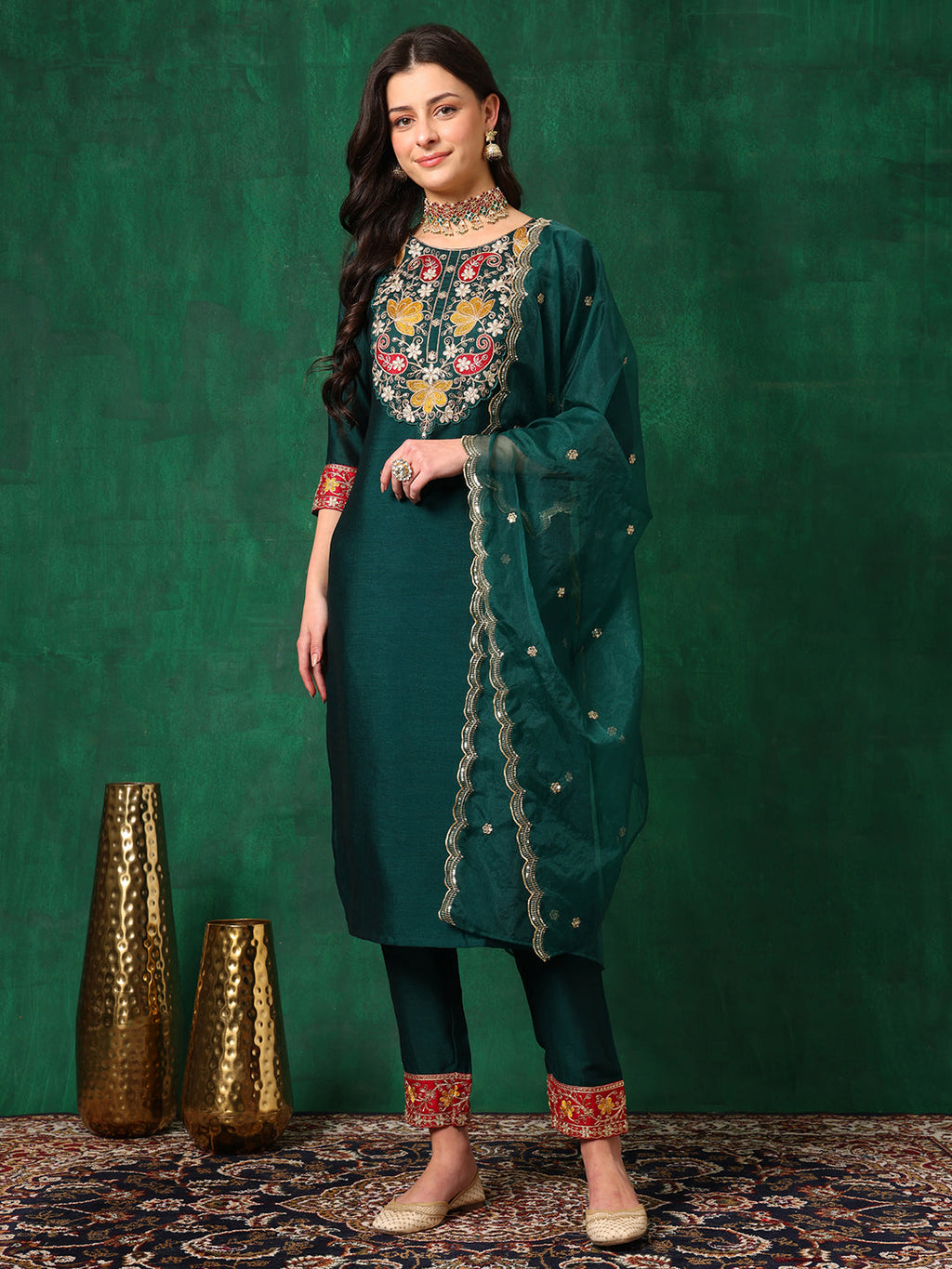 A stunning Bottle-Green embroidered silk-blend kurta paired with matching pants and a decorative dupatta.