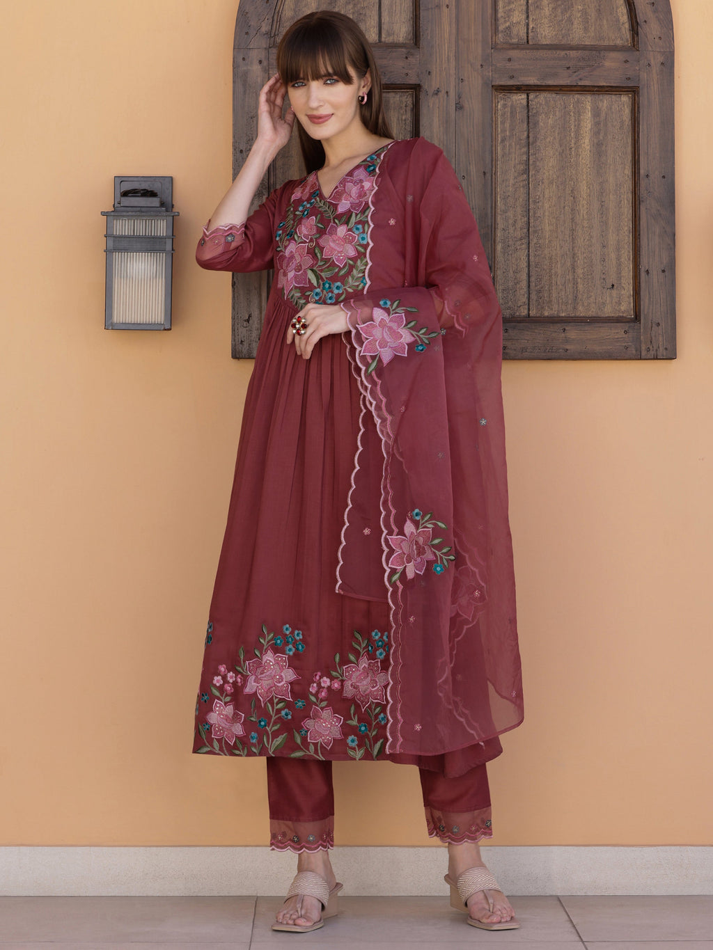 Rust colored A-line embroidered kurta set with pant and dupatta