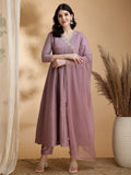 A mauve Angrakha-style Anarkali kurta set in chinnon fabric with intricate embroidery, paired with pants and a dupatta.