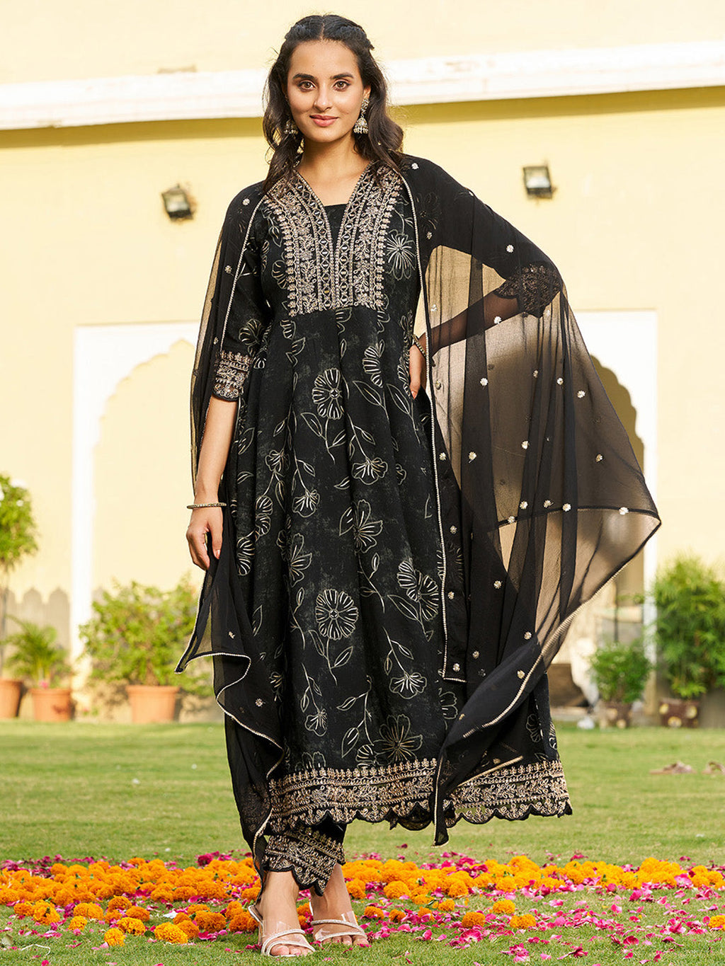 Elegant black Anarkali kurta with intricate mirror embroidery, matching pants, and a sheer chiffon dupatta.
