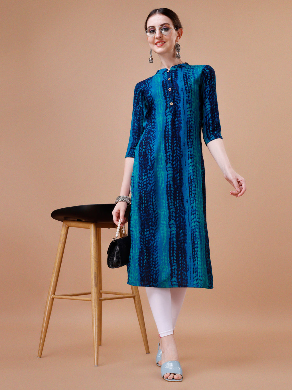 A woman wearing a vibrant multicolor Shibori printed rayon kurta with 3/4th sleeves.