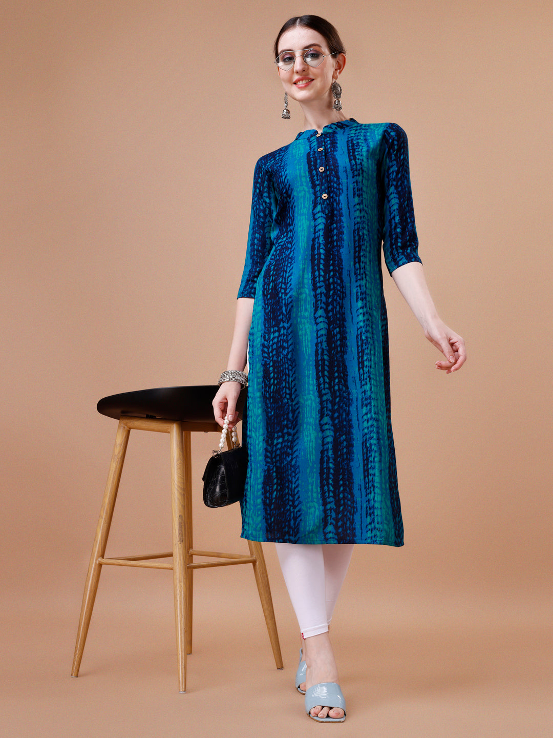 A woman wearing a vibrant multicolor Shibori printed rayon kurta with 3/4th sleeves.