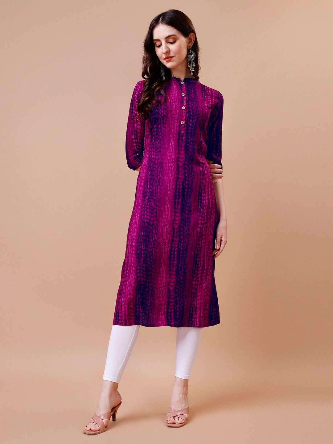 Woman wearing a vibrant multicolor Shibori printed rayon casual kurta with 3/4th sleeves and a round neck.