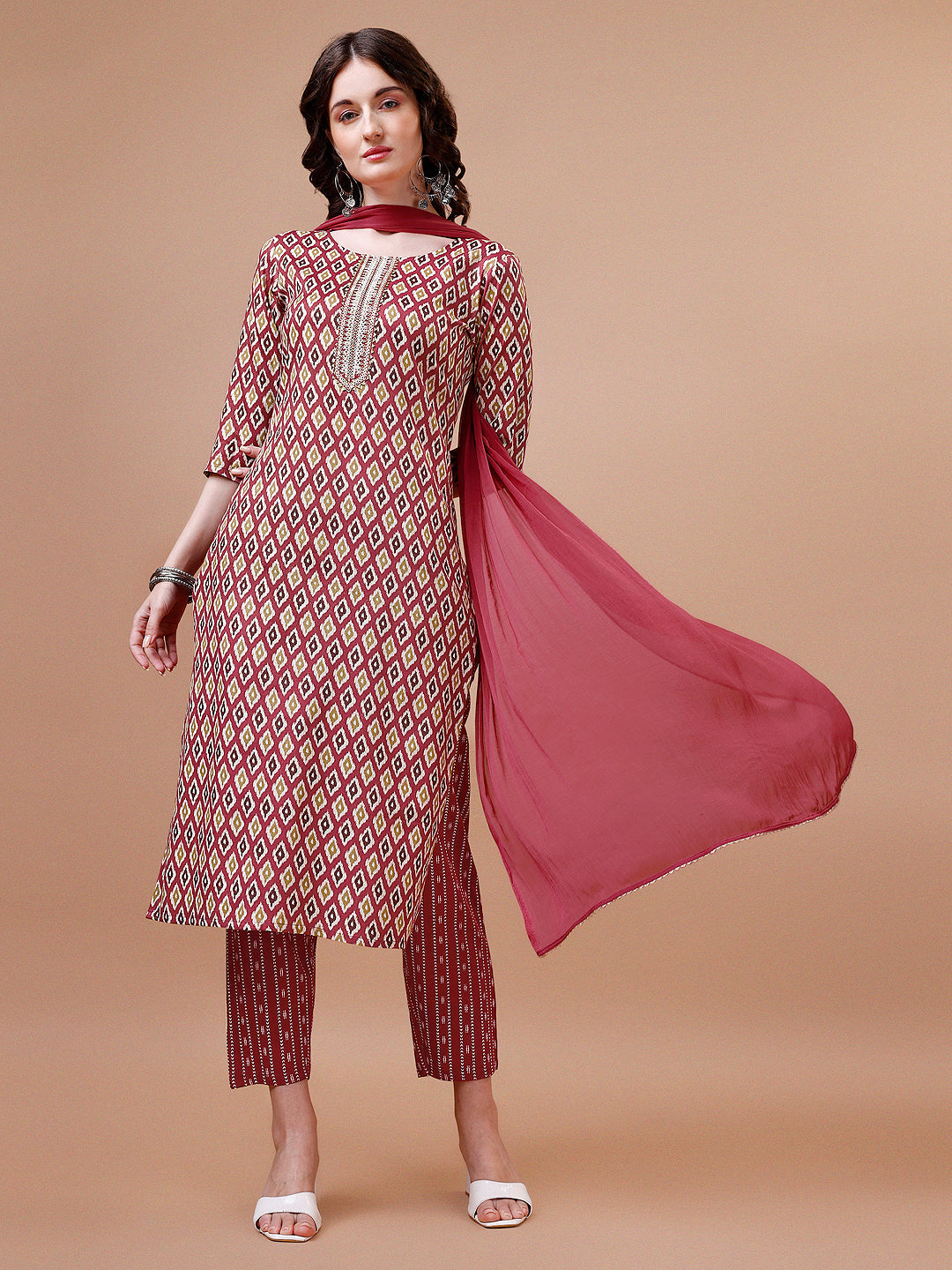 Woman wearing a multicolor ethnic motif printed rayon kurta set with pant and dupatta