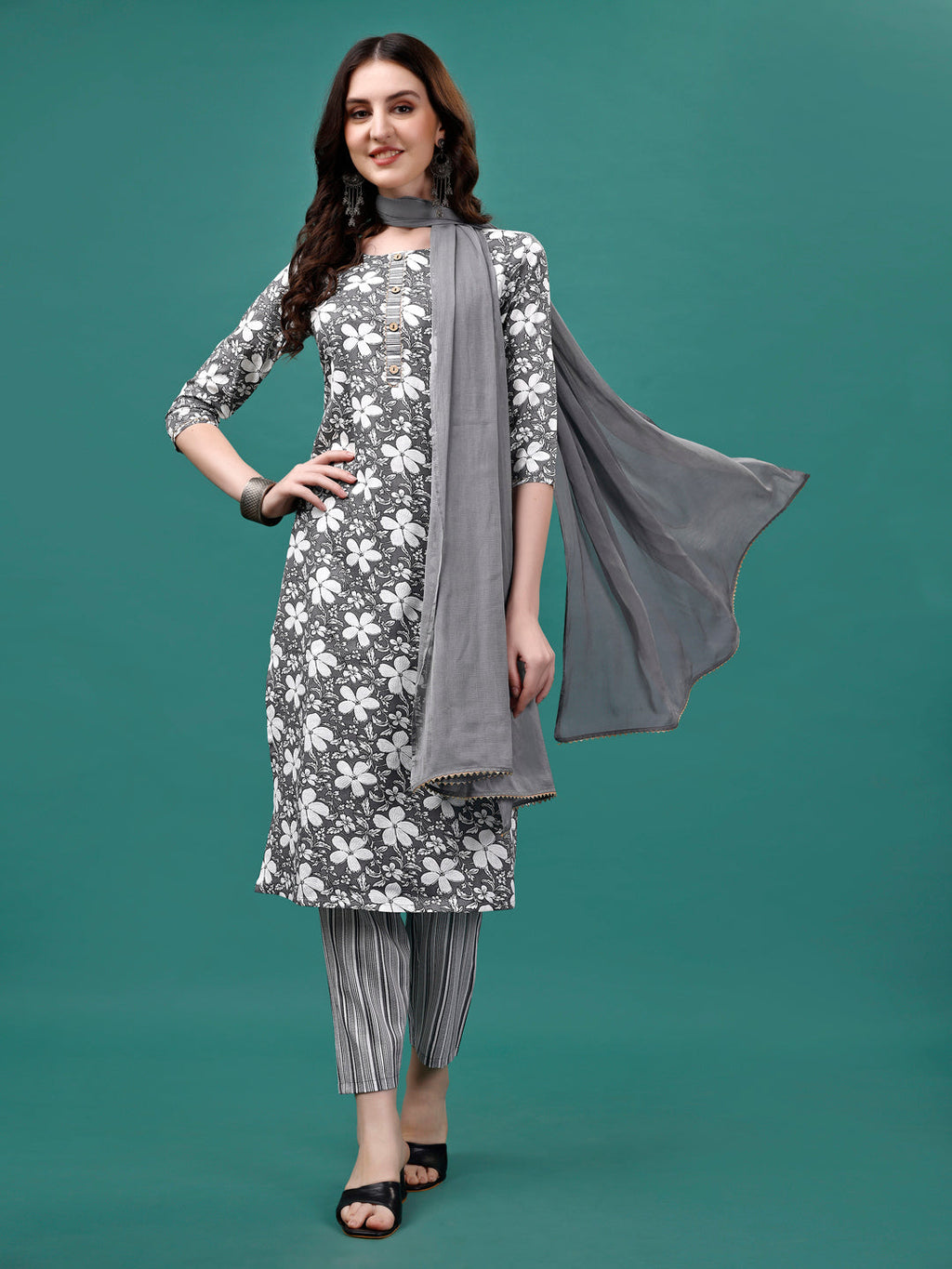 A woman wearing a multicolor floral printed rayon kurta set with matching pants and a dupatta.