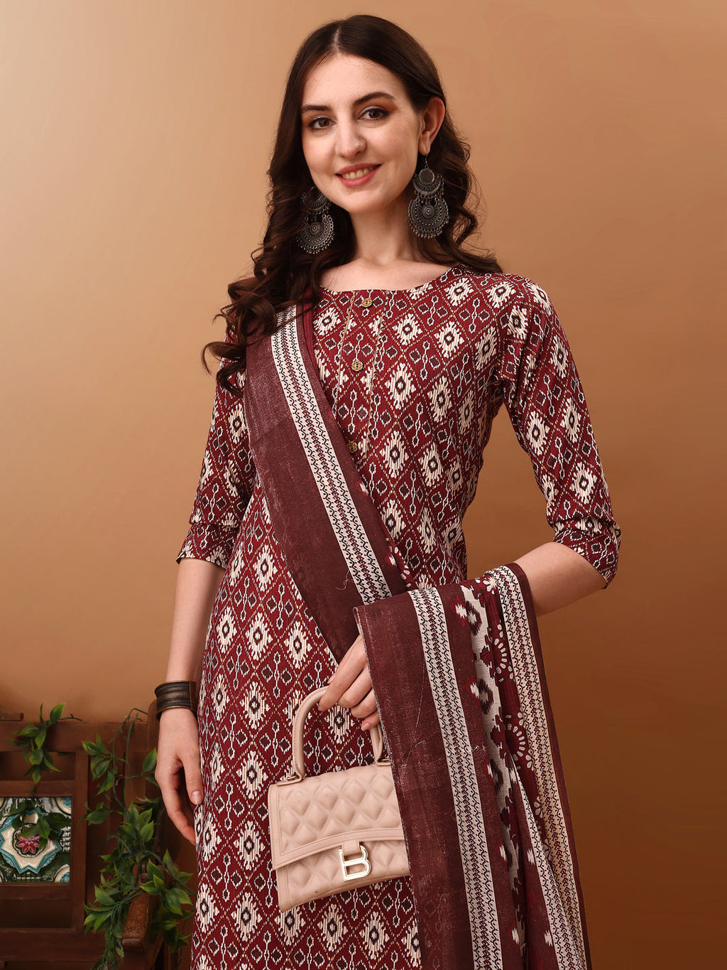 Wine colored ethnic motifs printed kurta set with matching pants and dupatta by Hiral Fashion