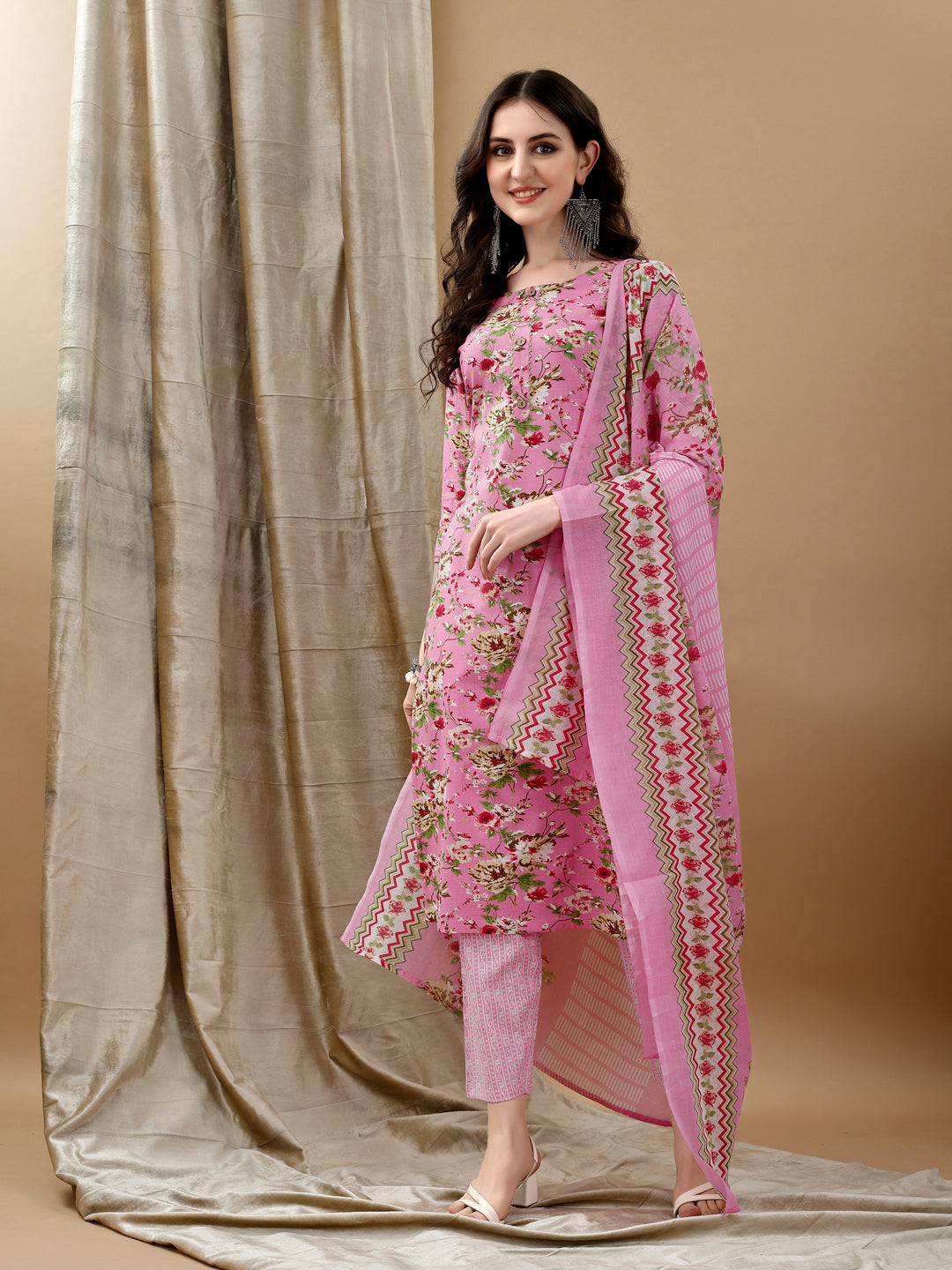 Pink cotton kurta set with floral print featuring 3/4th sleeves and matching pants and dupatta.