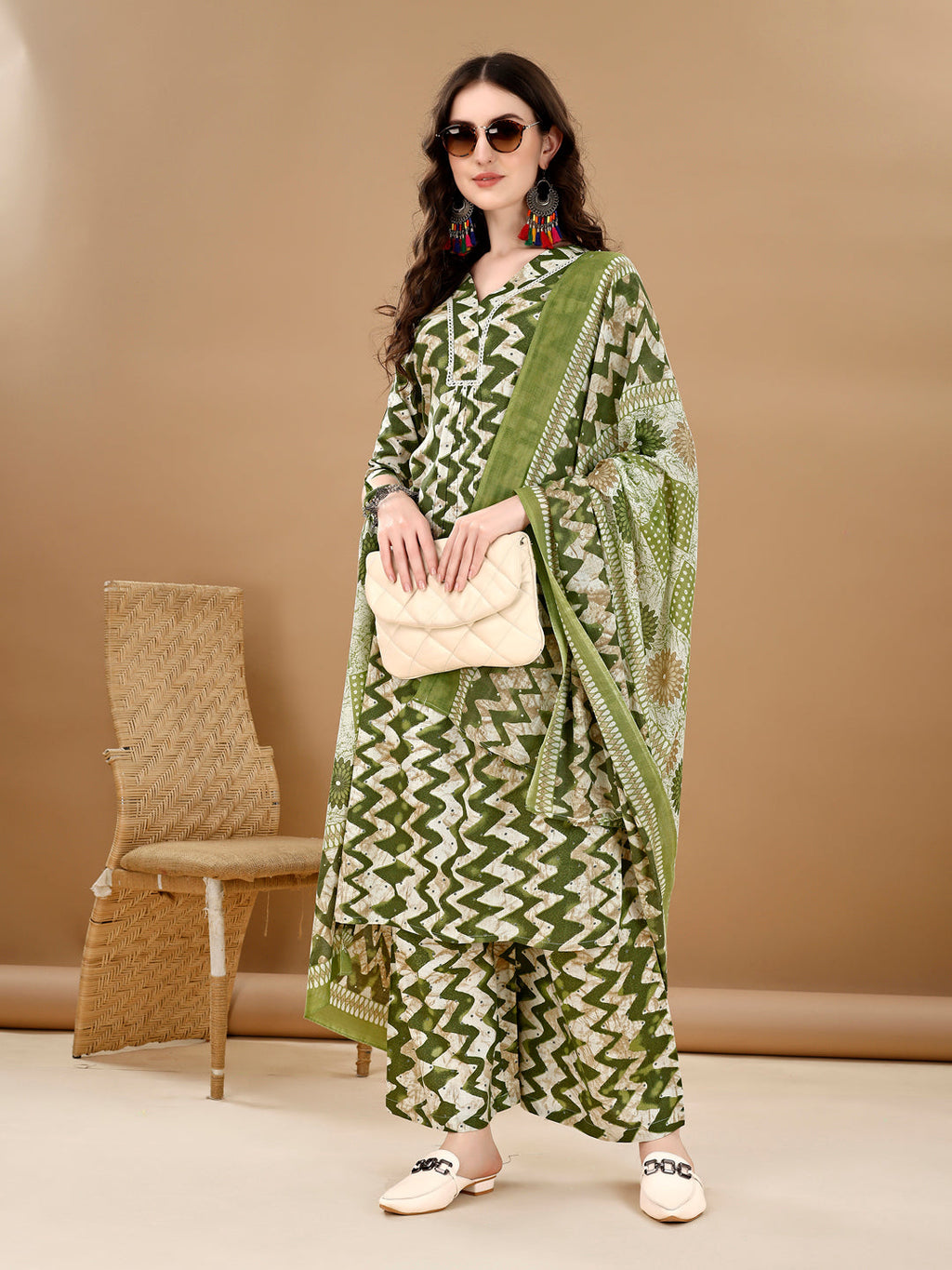 Model wearing a green chevron printed kurta with palazzo pants and a matching dupatta