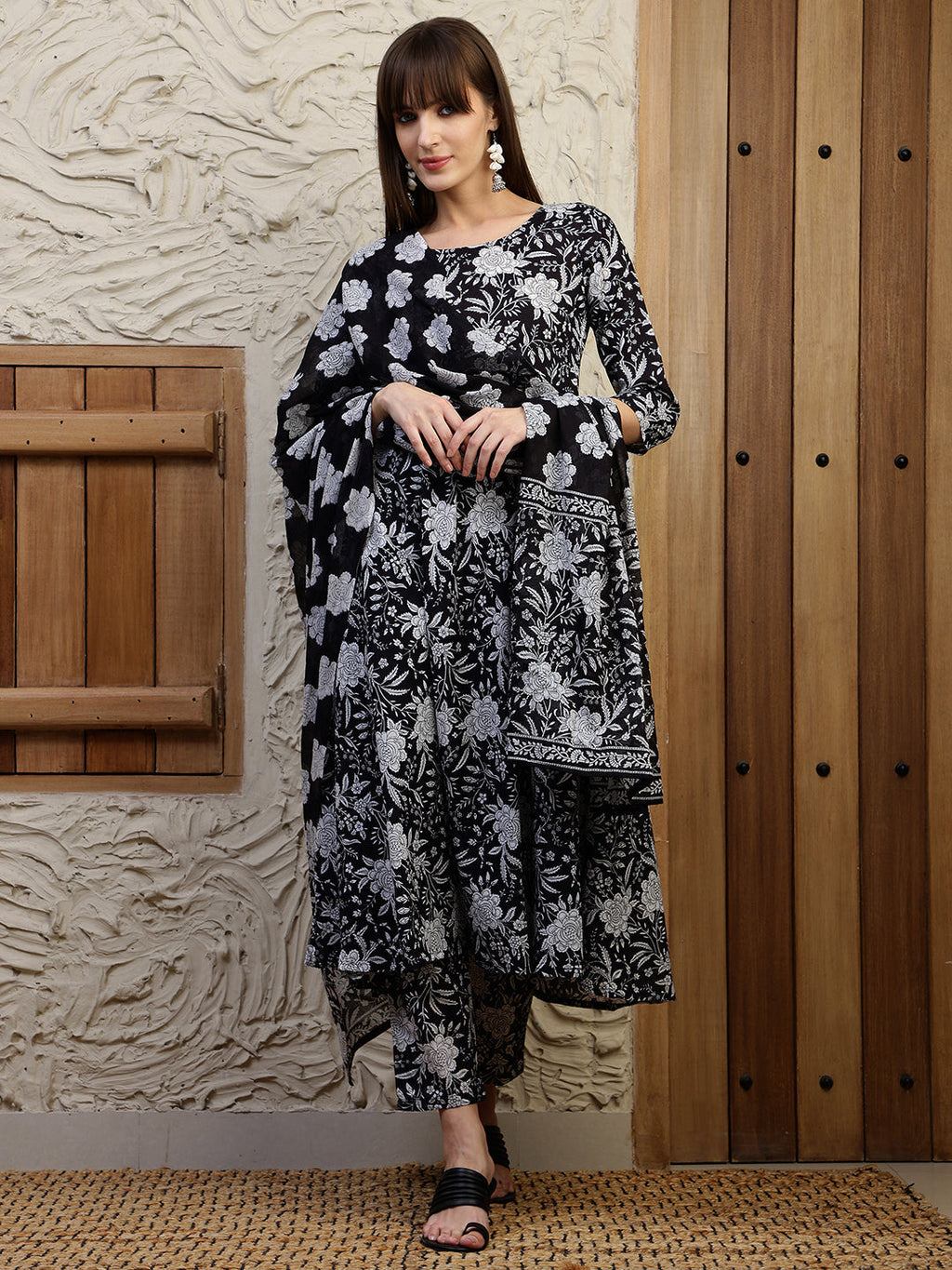 Black flared kurta with floral print featuring 3/4th sleeves and matching pants