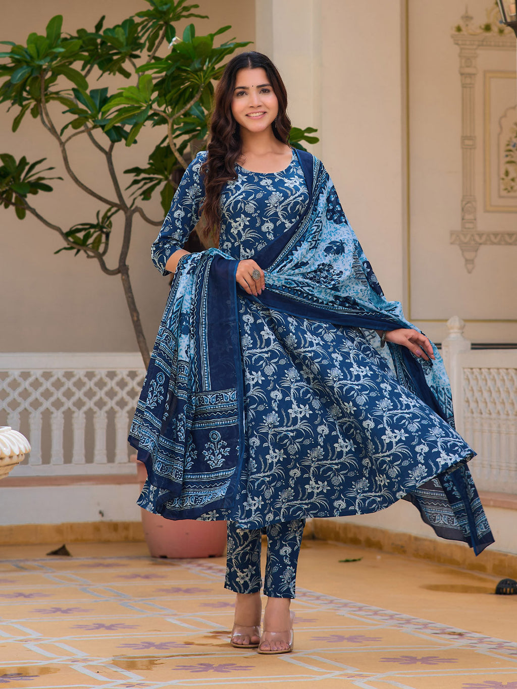 Blue floral printed flared kurta set paired with matching trousers and a dupatta