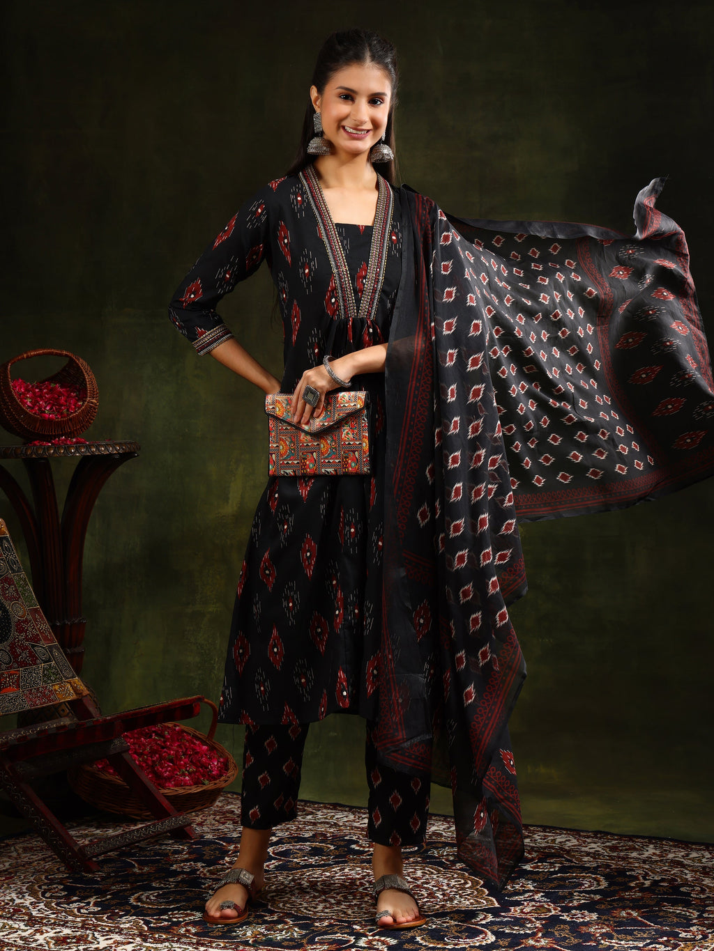 Black A-line kurta with ethnic motifs, paired with matching pants and dupatta