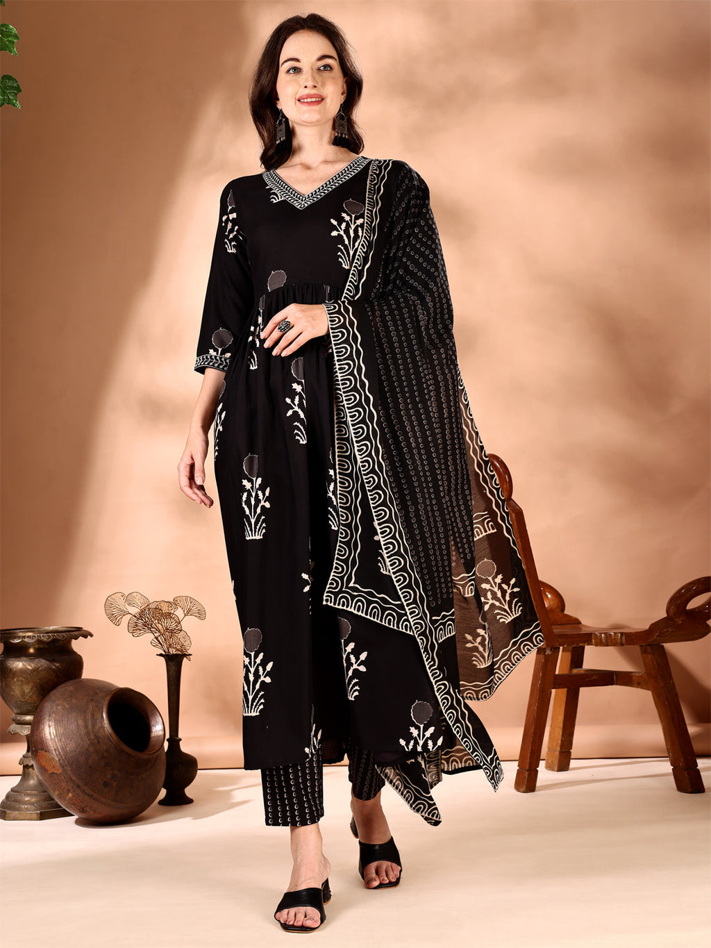 Black flared kurta featuring ethnic motif prints and embroidery with matching pants and dupatta.