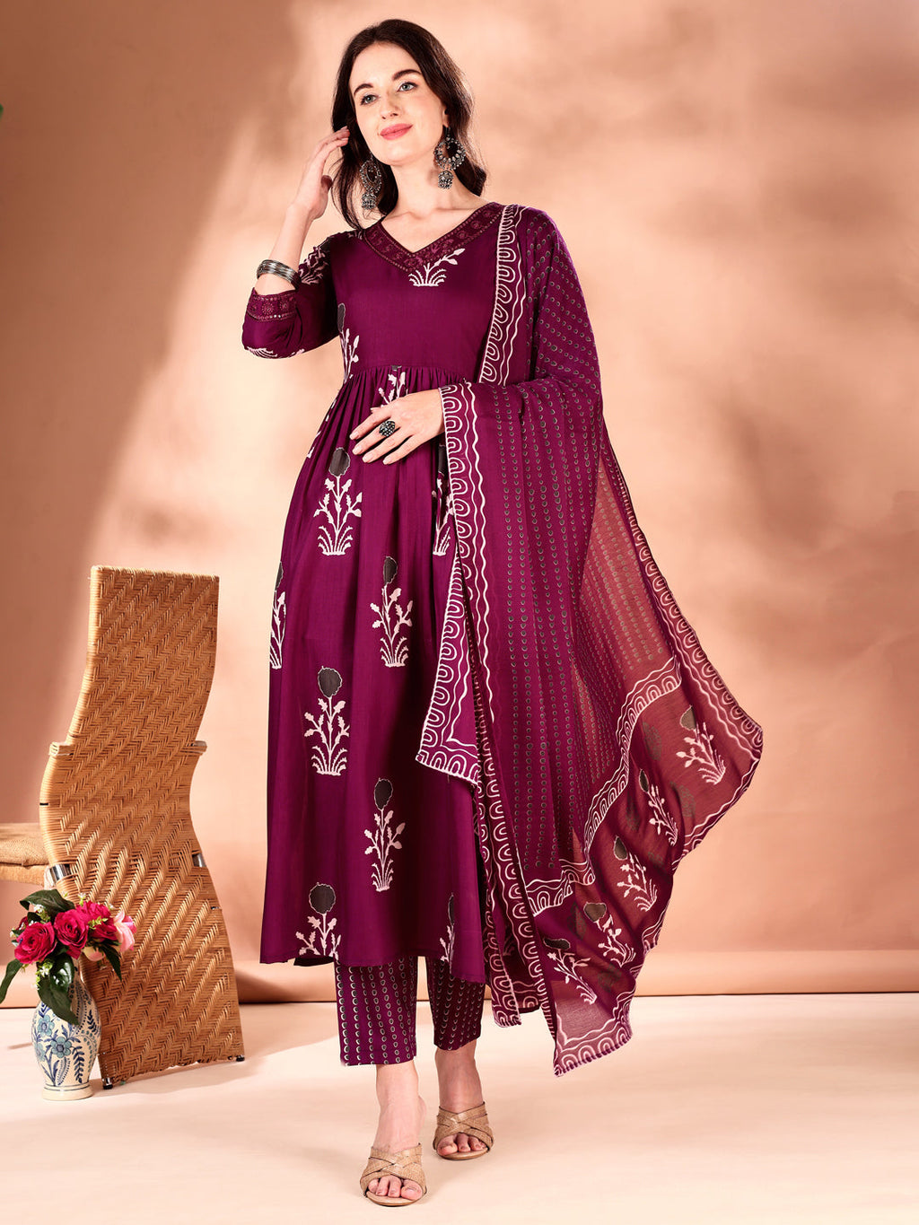 Purple flared kurta with ethnic embroidery, matching pants, and a dupatta.