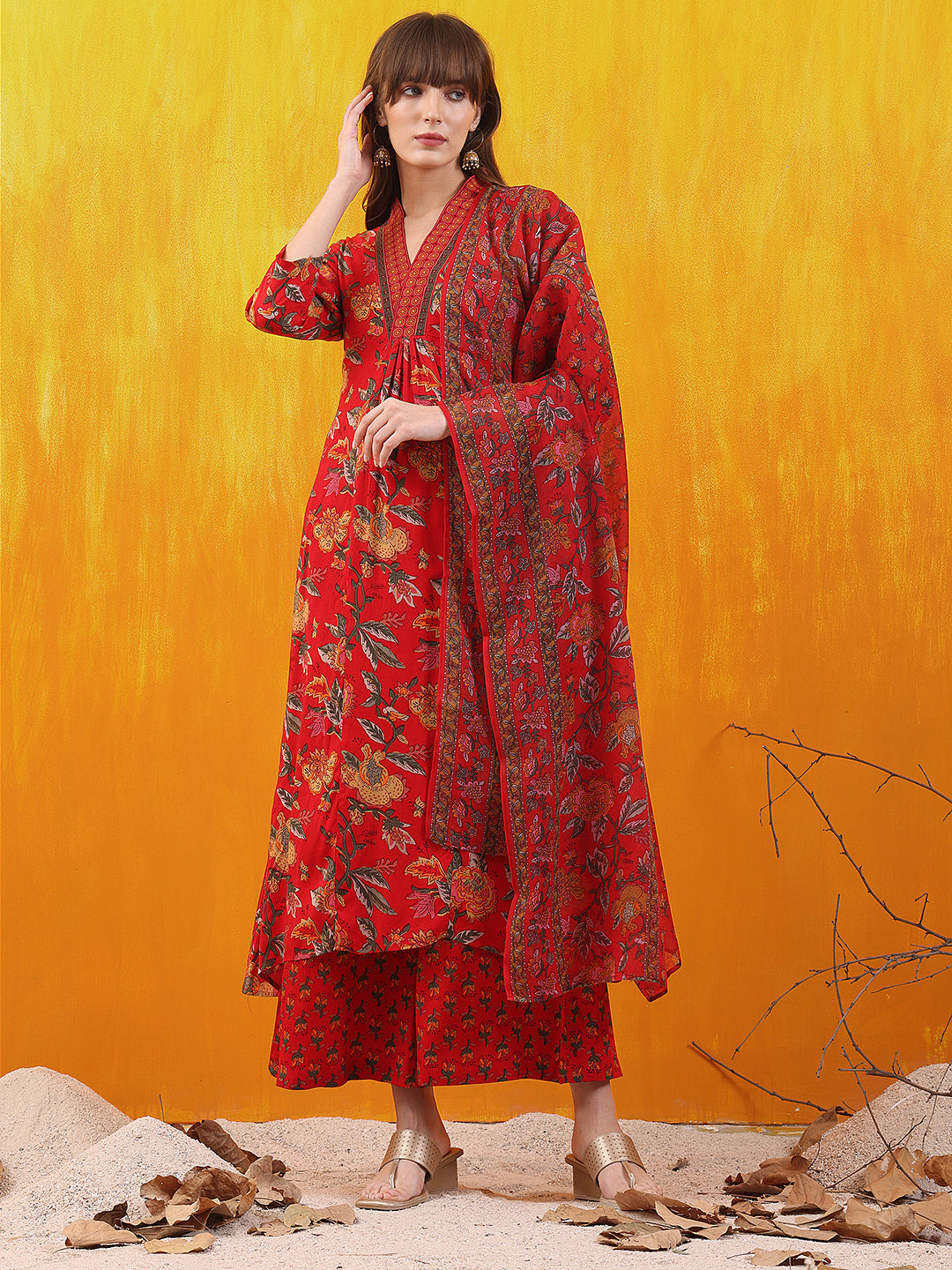 Red A-line flared kurta with floral prints, styled with comfortable palazzo pants and a dupatta.