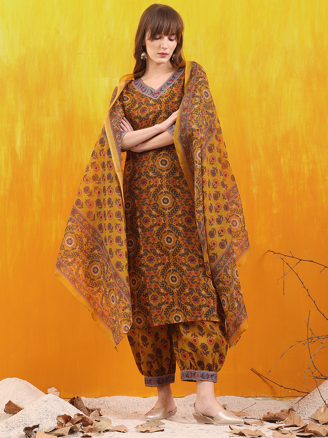 Mustard printed kurta paired with matching Afghani pants and a dupatta.