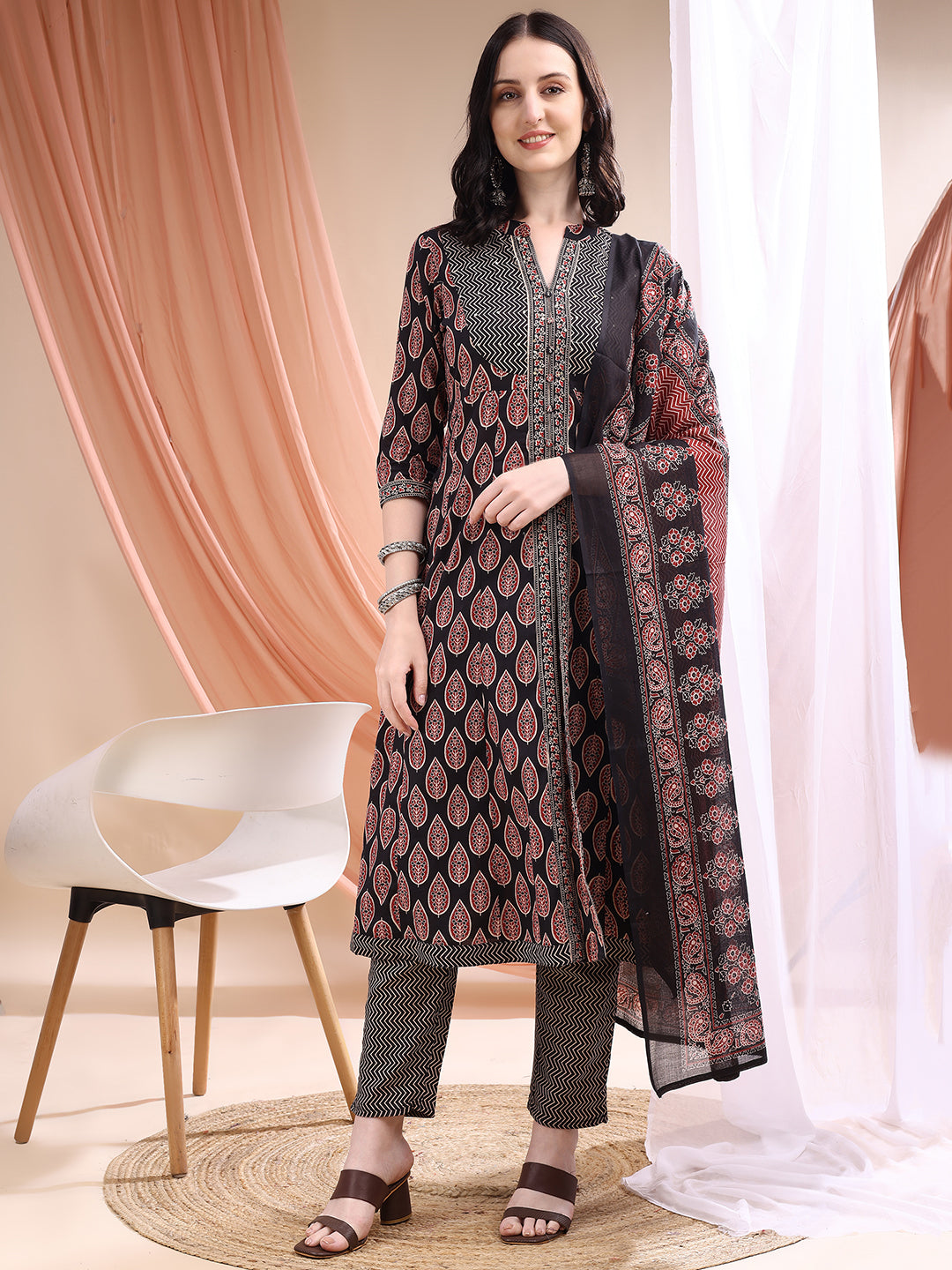 Black A-line cotton kurta with front slit and printed motifs paired with matching pants.