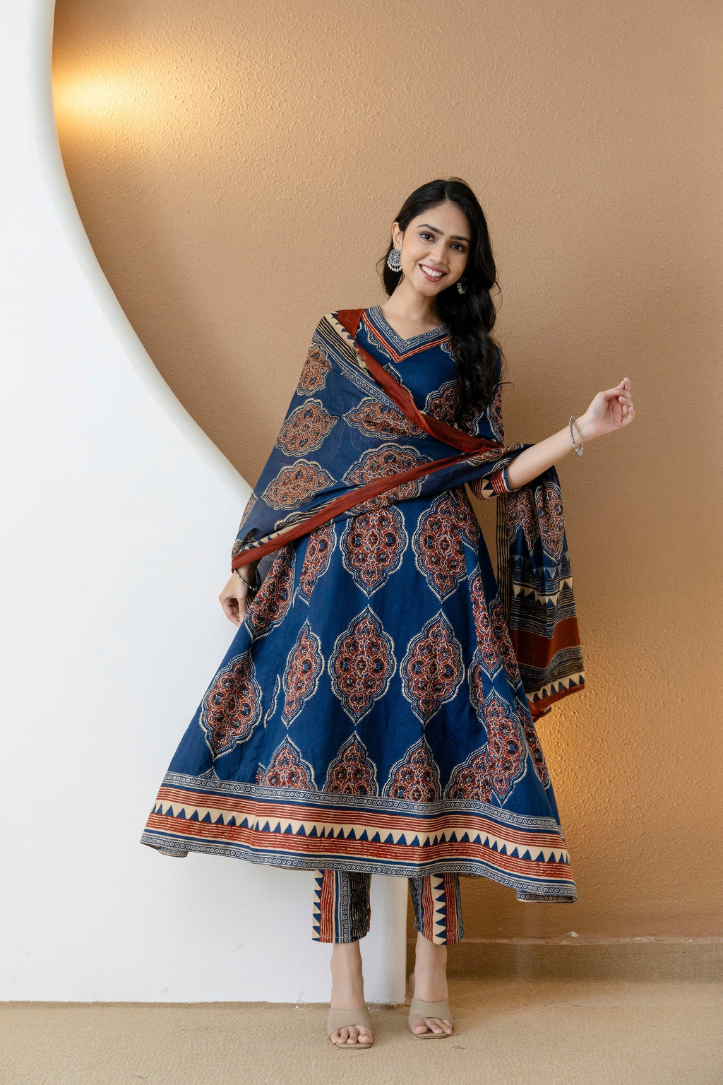 Blue Anarkali kurta set with ethnic motif print, featuring matching pants and dupatta.