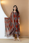 Rust colored Anarkali kurta set with ethnic motif prints, matching pants, and a dupatta by Hiral Fashion