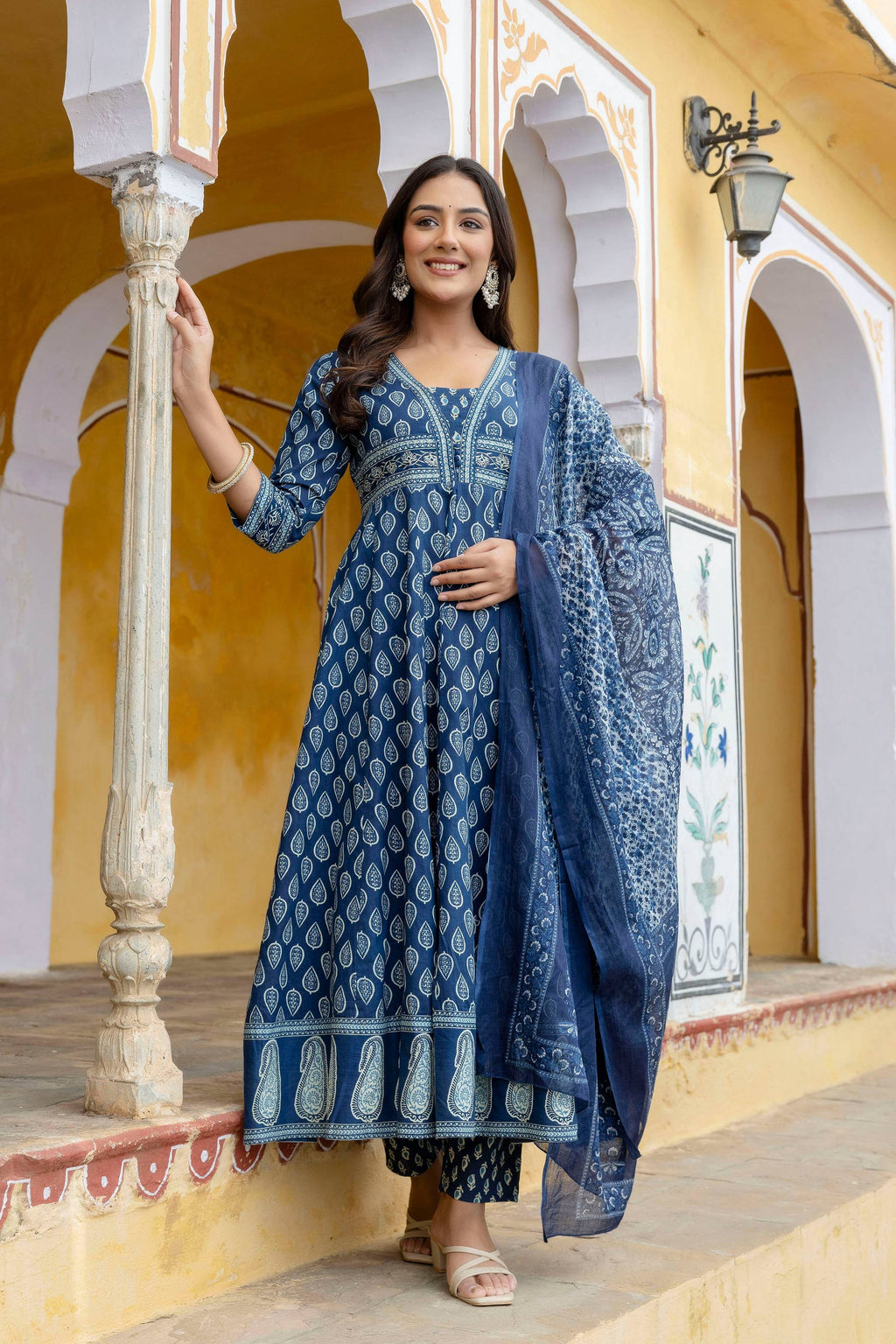 A blue ethnic printed Anarkali kurta set made of cotton with a matching flowy dupatta.