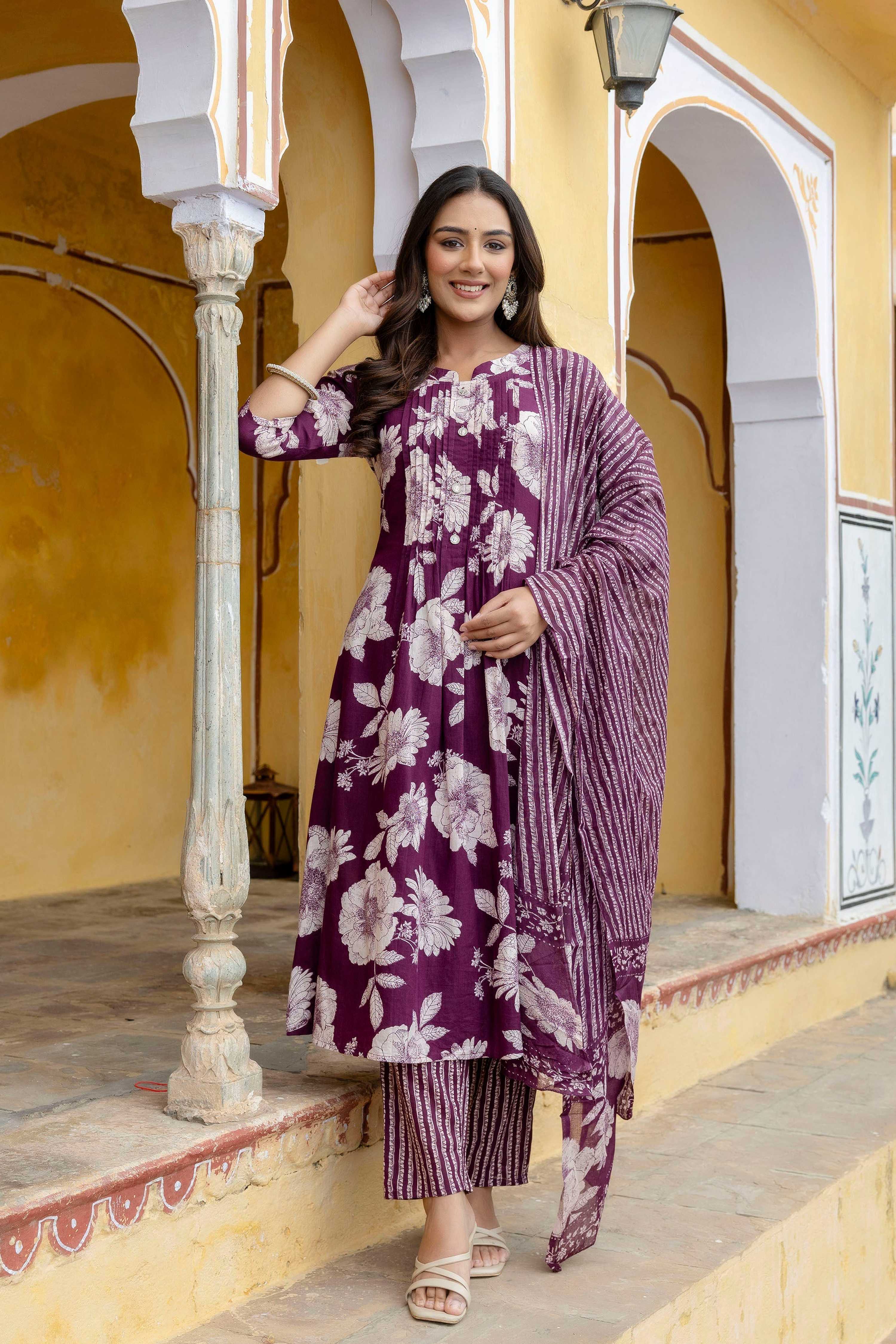 Woman wearing a purple floral printed cotton kurta set with a matching striped dupatta