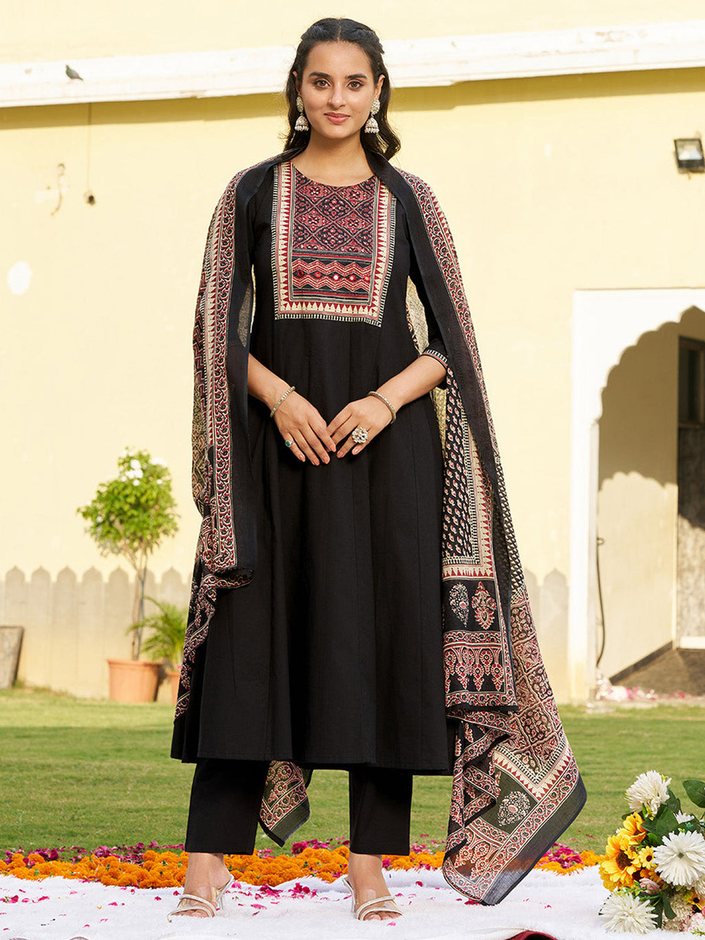 Black Anarkali kurta set with embroidered details and ethnic print pattern.