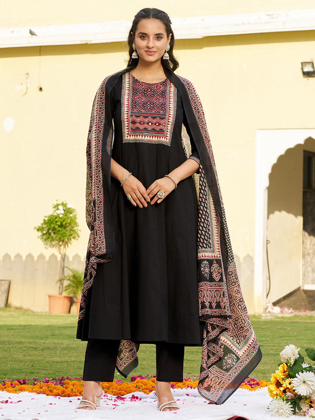 Black Anarkali kurta set with embroidered details and ethnic print pattern.