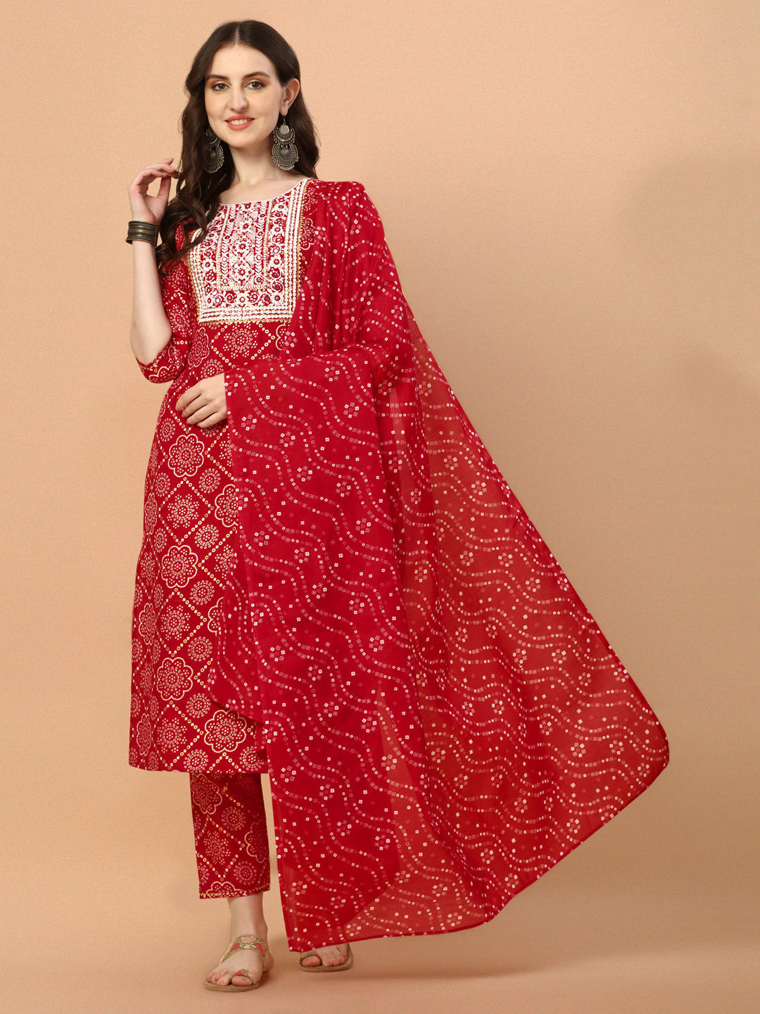 Woman wearing a multicolor Bandhani printed and embroidered rayon kurta set with pant and dupatta.