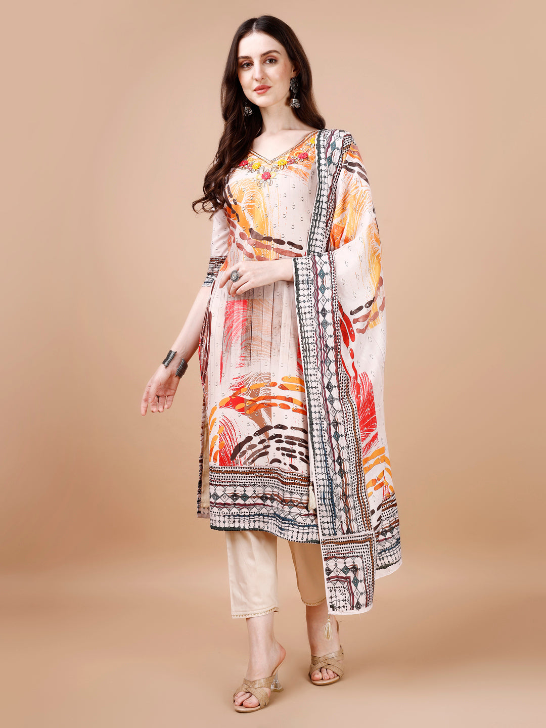 Woman wearing a hand-embroidered multicolor muslin kurta set with matching pants and dupatta