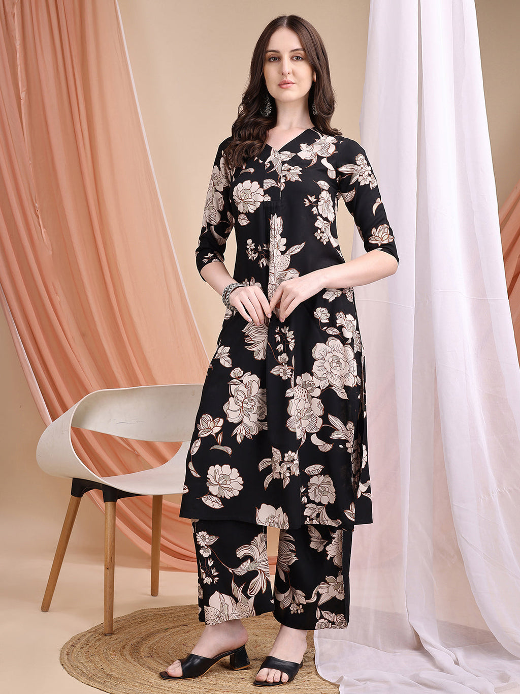 Woman wearing a black floral printed kurta with matching palazzo pants and V-neckline