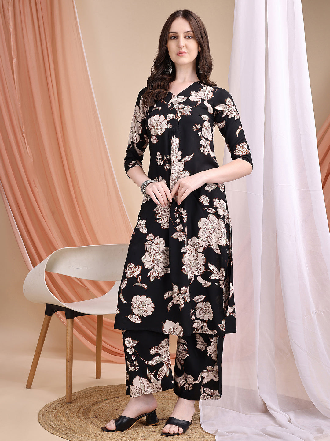 Woman wearing a black floral printed kurta with matching palazzo pants and V-neckline