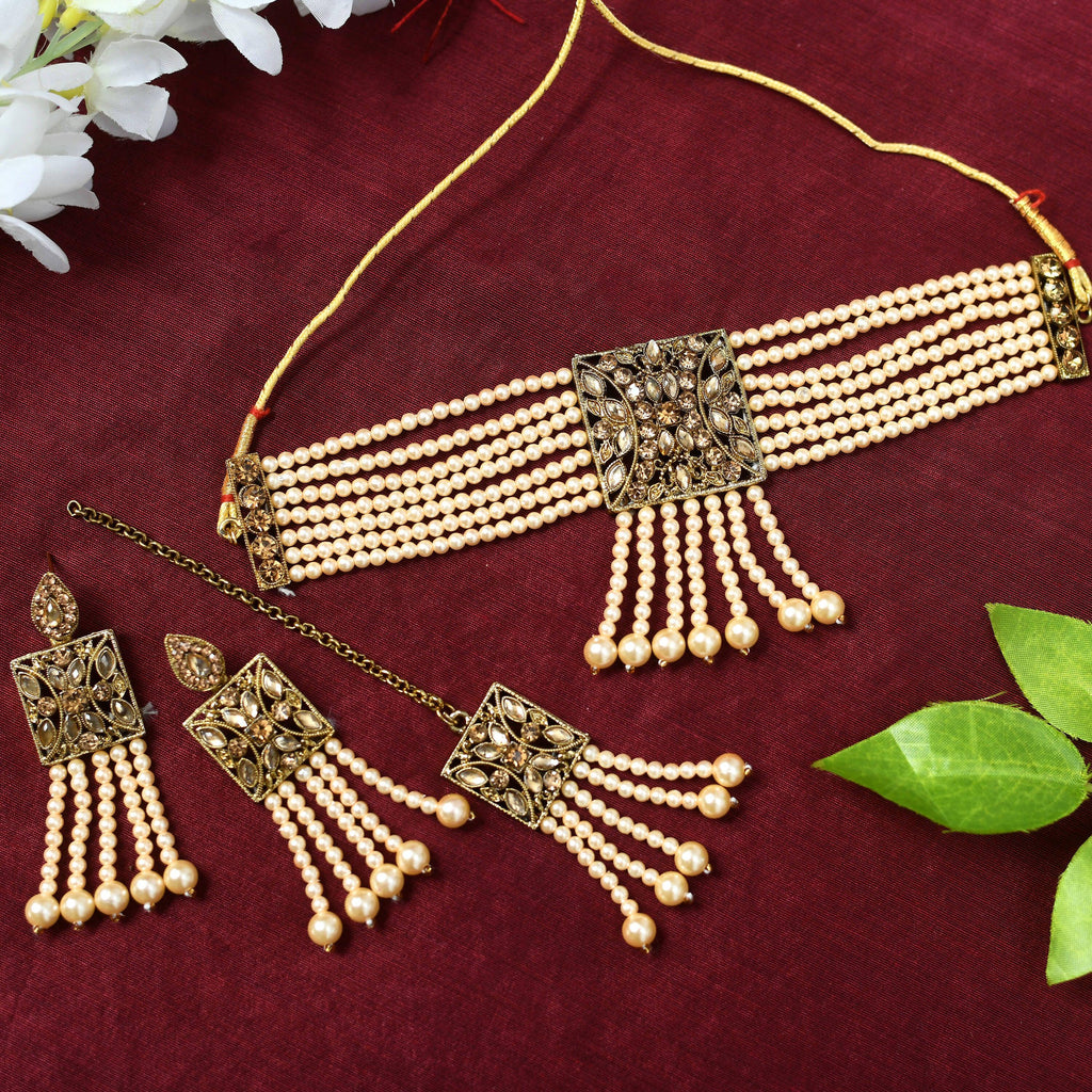 Off-white Kundan and pearl choker necklace set with golden brass finish