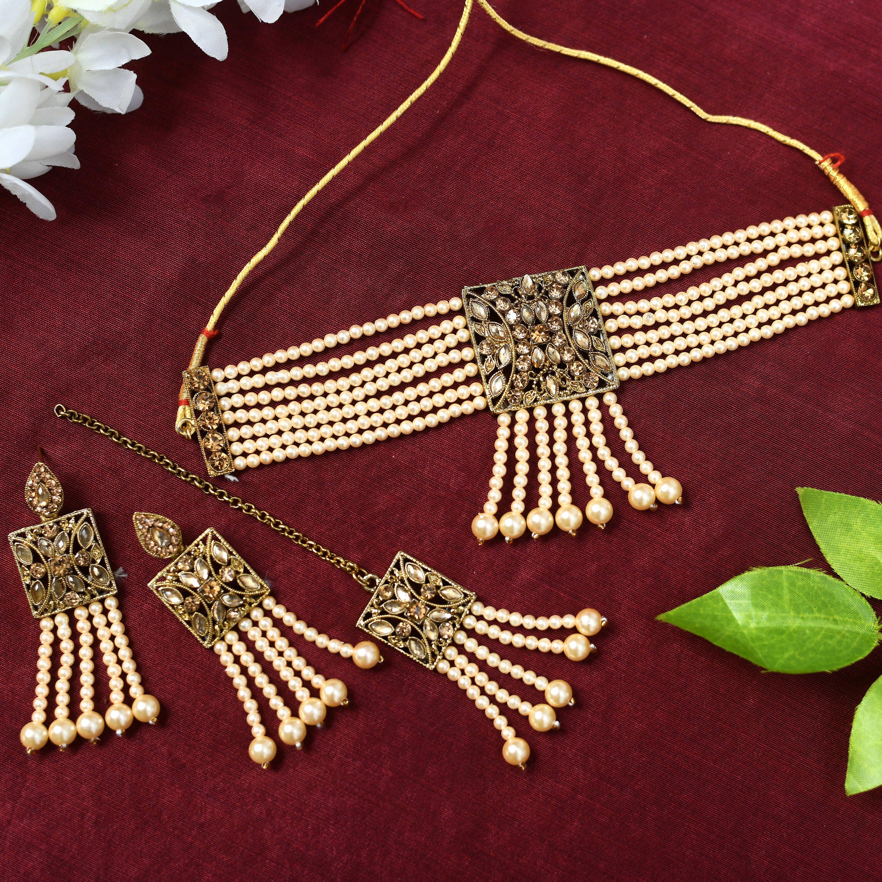 Off-white Kundan and pearl choker necklace set with golden brass finish