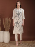 Woman wearing a white cotton co-ord set with floral embroidery and a sweetheart neckline
