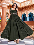 Woman wearing a floor-length dark green georgette gown with heavy zari and sequin embroidery work.