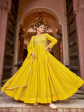 Model wearing a vibrant yellow georgette gown with intricate gold zari and sequins embroidery work