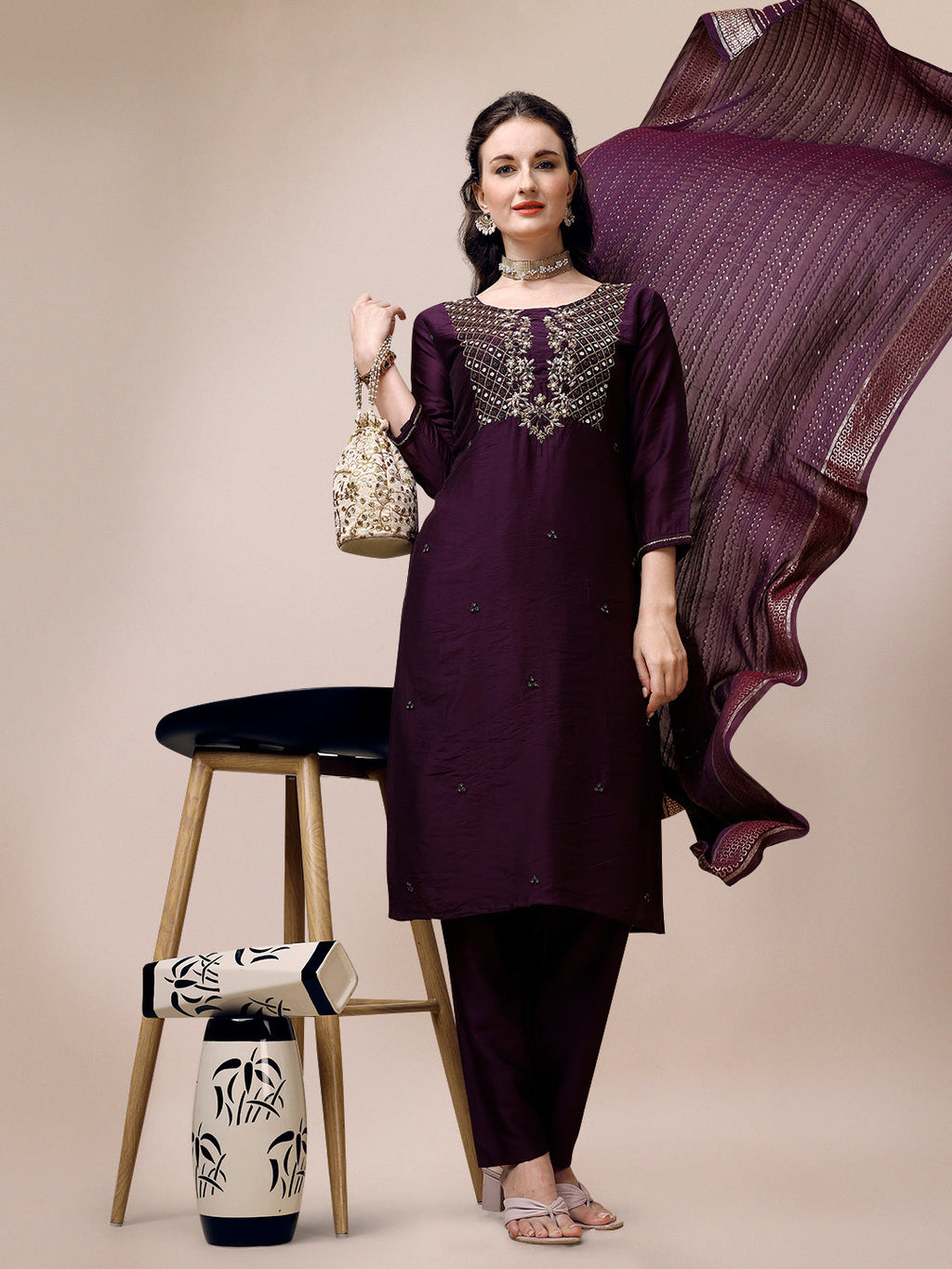 Woman wearing a multicolor hand embroidered Chanderi kurta set with pant and matching dupatta.