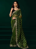 Green net saree with a luxurious black velvet blouse for a modern party look.