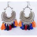 Afghani style hanging earrings with colorful silk threads and silver oxidized metal detail.