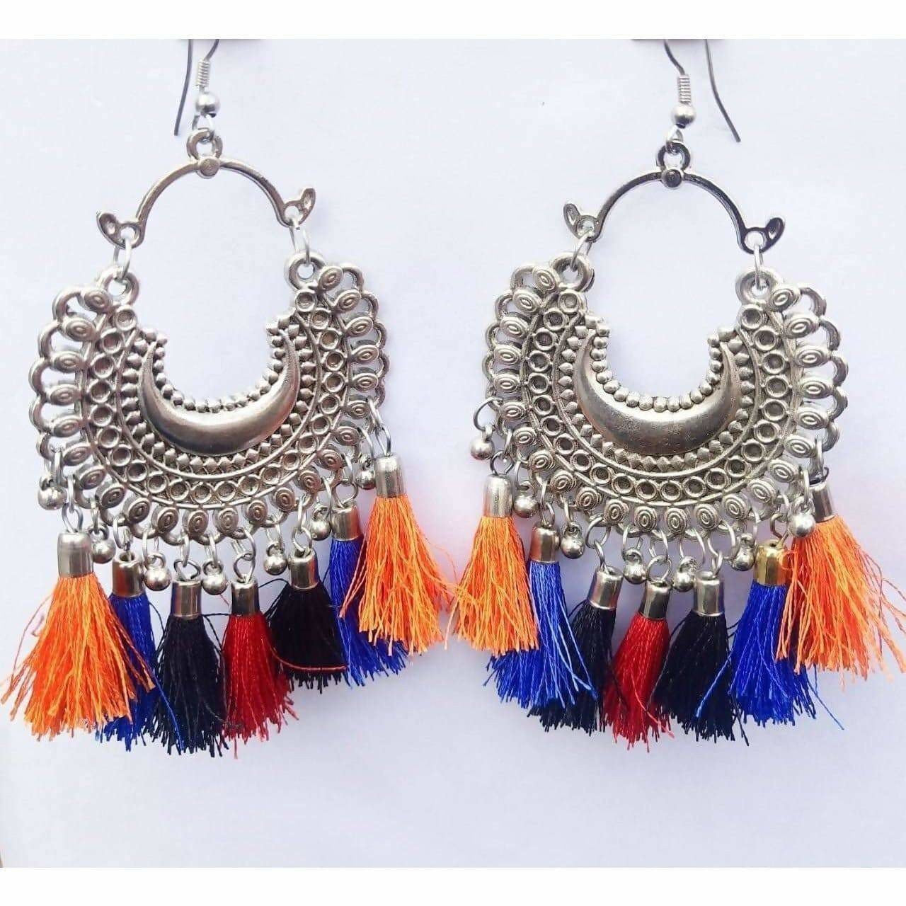Afghani style hanging earrings with colorful silk threads and silver oxidized metal detail.
