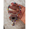 Silver-toned bangle adorned with multicolor pearls and a mirror-design jhumka charm