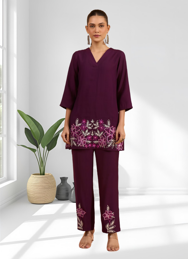Model wearing a wine silk embroidered readymade cord set with V-neck top