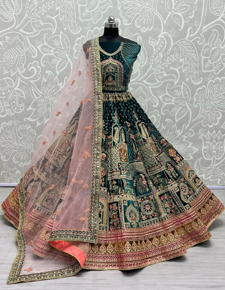 Teal green velvet lehenga choli with dori, sequins, and multi-thread embroidery.