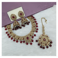 Classic maroon stone work necklace set on a textured background
