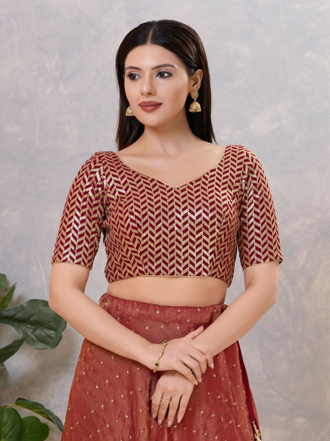 Maroon silk stitched blouse with a stylish V-neck design.