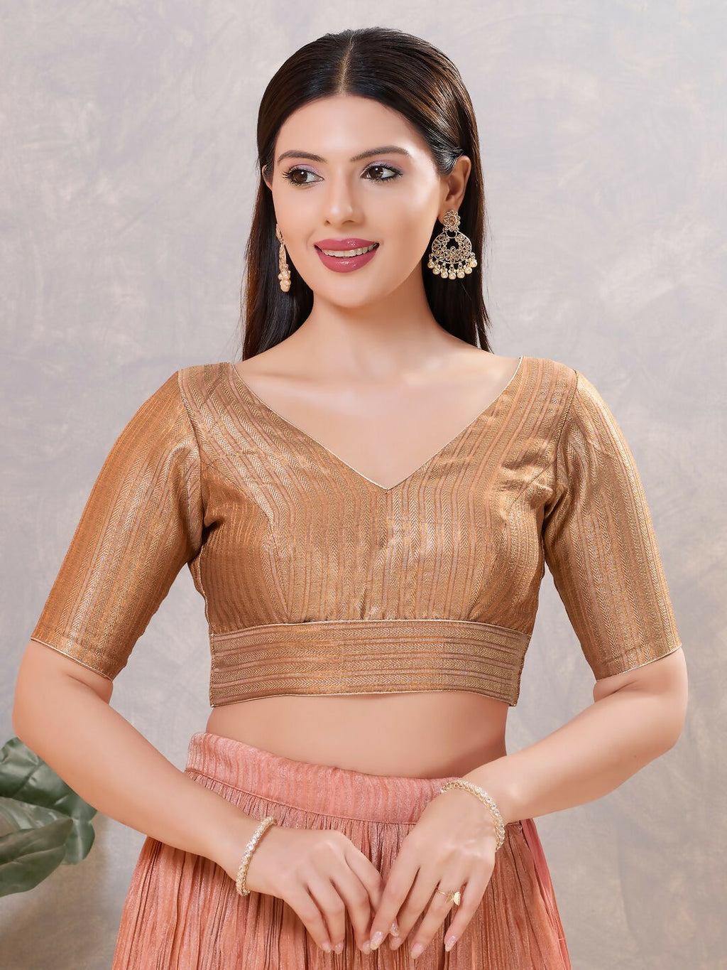 Close-up of a women's copper-colored jacquard stitched blouse with a V-neck and elbow sleeves